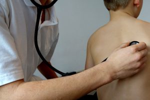 רופא ילדים בודק ילד עם סטטוסקופ